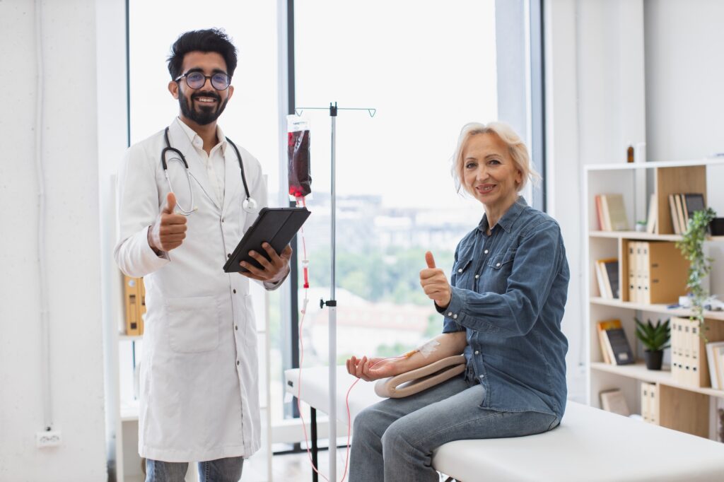 Healthcare practitioner consulting female patient with cancer in clinic.